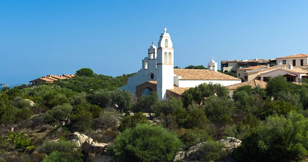 Village in Sardinia on a hill with a white church and bell tower
