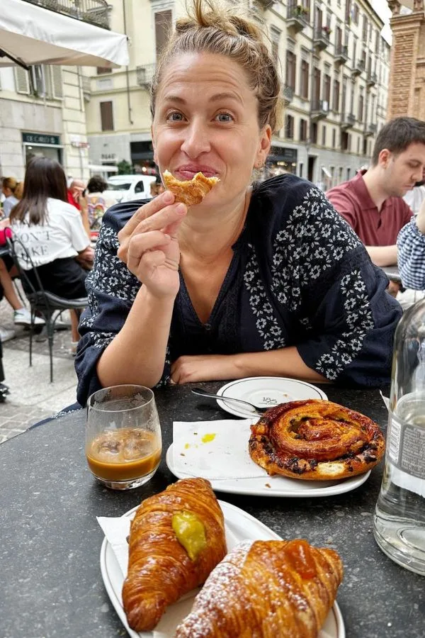 Happy woman eating a cornetto in Turin, Italy- Barrett and the Boys