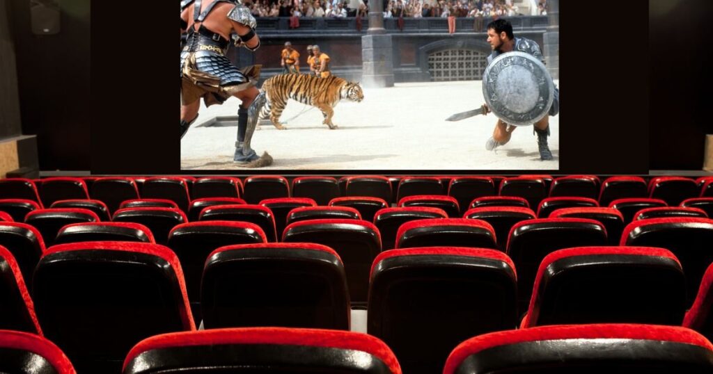 Gladiator film directed by Ridley Scott on a screen in a theater with red velvet seats